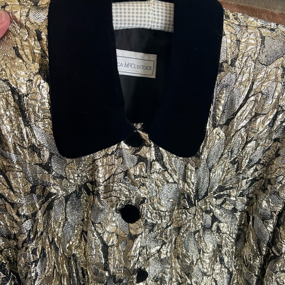 Velvet jacket with metallic gold decoration around bodice. Jacket is mid thigh